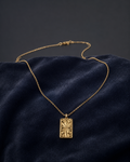 Vintage Sunburst Rectangular Gold Pendant Necklace on dark velvet background