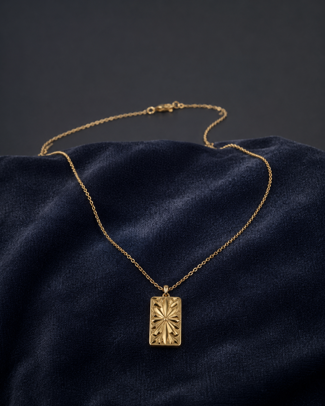 Vintage Sunburst Rectangular Gold Pendant Necklace on dark velvet background