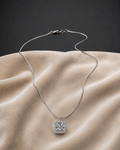 Classic Silver Halo CZ Pendant Necklace on sleek snake chain displayed on beige fabric
