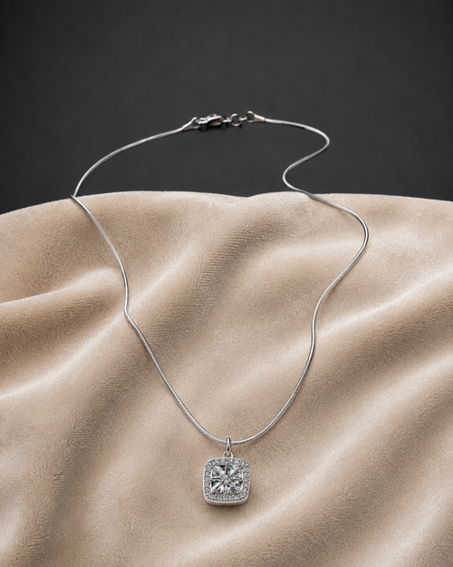 Classic Silver Halo CZ Pendant Necklace on sleek snake chain displayed on beige fabric