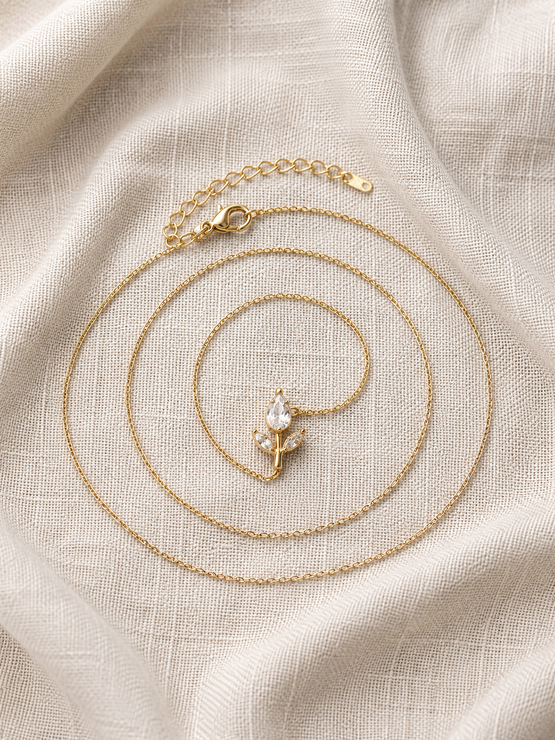 Dainty Crystal Flower Pendant Necklace on linen fabric